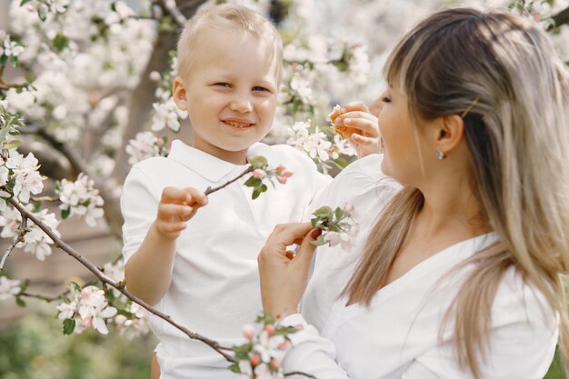 Mother with little son playing in a summer yard