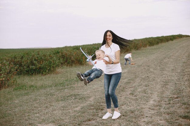 Mother with little son playing with toy plane