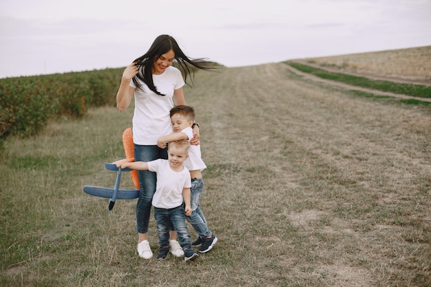 Mother with little son playing with toy plane