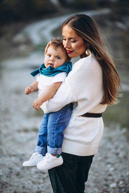 Mother with little son together in park