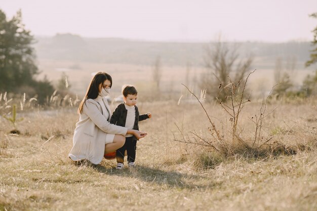 Mother with little son wearing masks