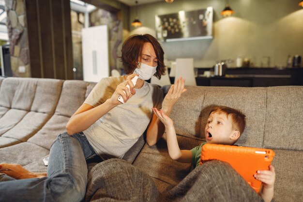 Mother with littler son sitting at home on quarantine