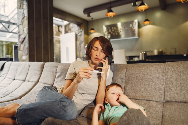 Mother with littler son sitting at home on quarantine