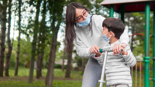 Free photo mother with reading glasses playing with her son