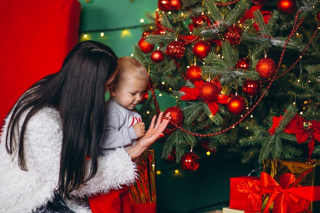 Mother with son by the Christmas tree