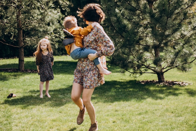 Mother with son and daughter having fun in the backyard