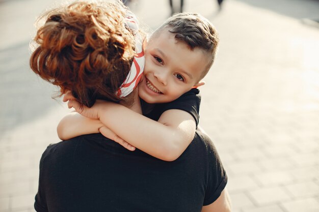 Mother with son playing in a summer city