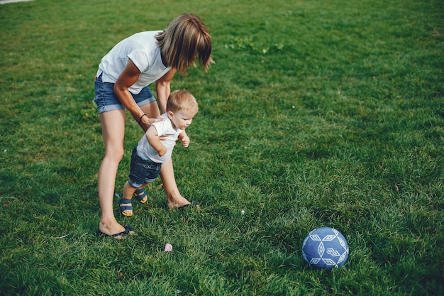 Free photo mother with son playing in a summer park