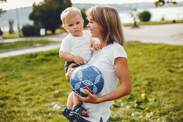 Mother with son playing in a summer park