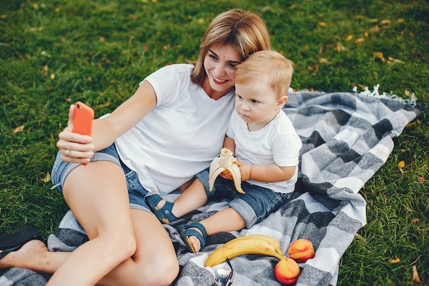 Mother with son playing in a summer park