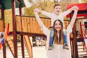 Free photo mother with son playing in a summer park