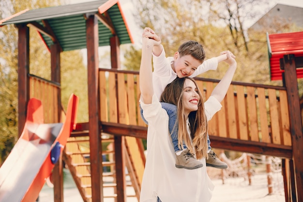 Mother with son playing in a summer park