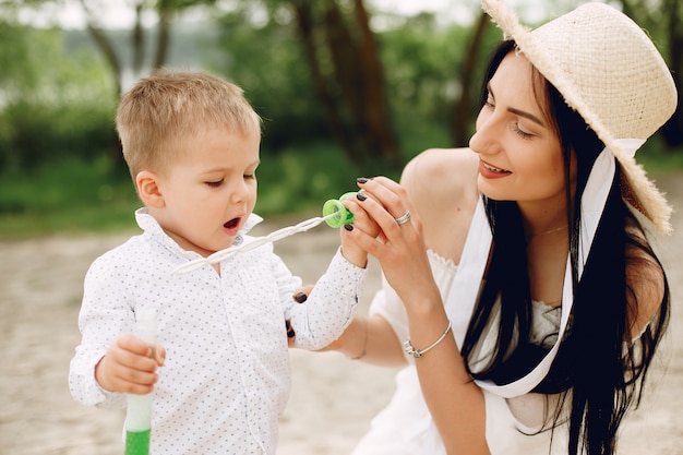 Mother with son playing in a summer park