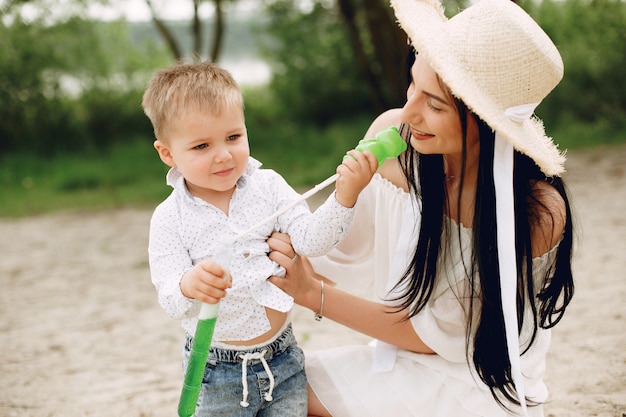 Mother with son playing in a summer park