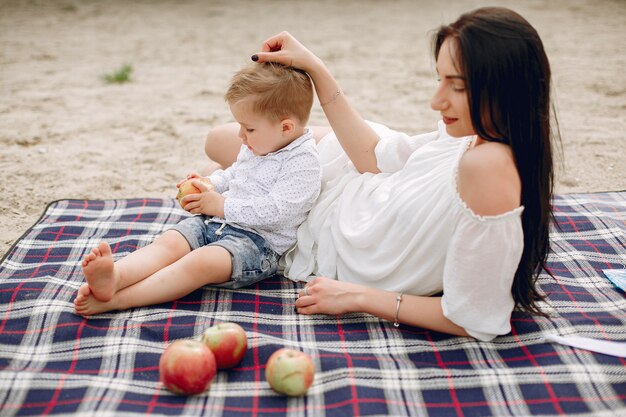 Mother with son playing in a summer park