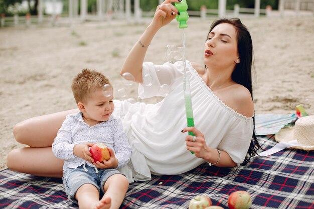 Mother with son playing in a summer park