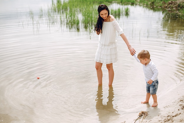 Free photo mother with son playing in a summer park