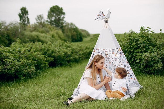 Mother with sonplaying in a summer field