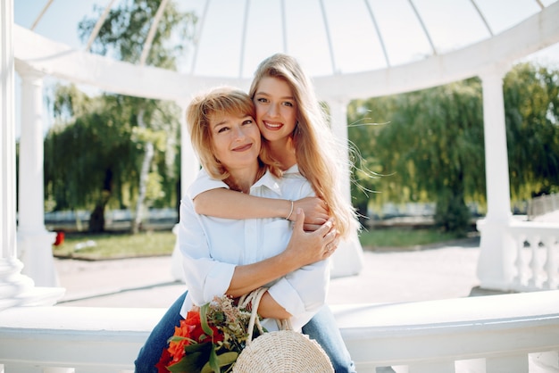 Free photo mother with young daughter in a summer park