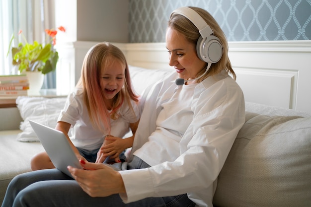 Free photo mother working from home trying to balance family life with child and job