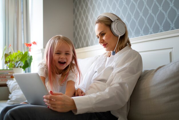 Mother working from home trying to balance family life with child and job