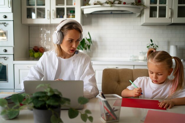 Mother working from home trying to balance family life with child and job