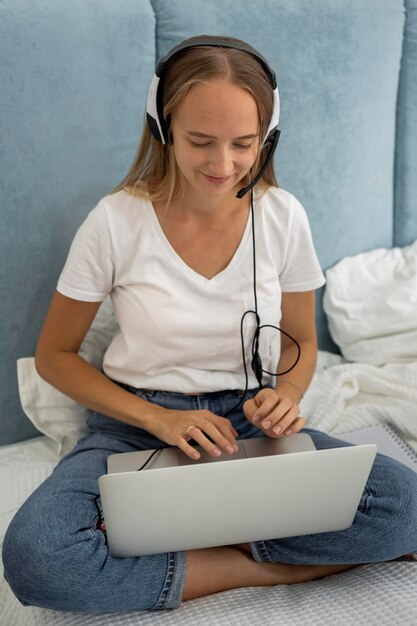 Mother working on laptop from home during quarantine with child