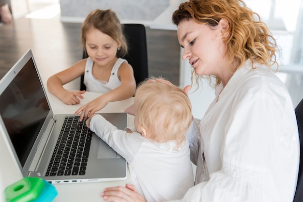 Mother working with baby at home