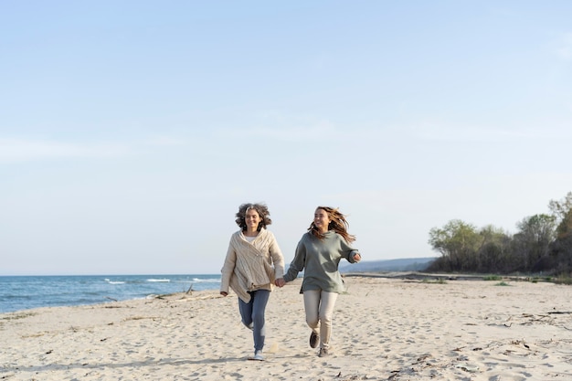 mother and young daughter spending time at the beach together