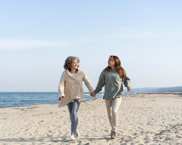 mother and young daughter spending time at the beach together