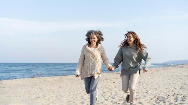 Mother and young daughter spending time at the beach together