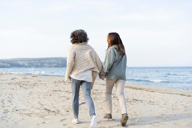 mother and young daughter spending time at the beach together