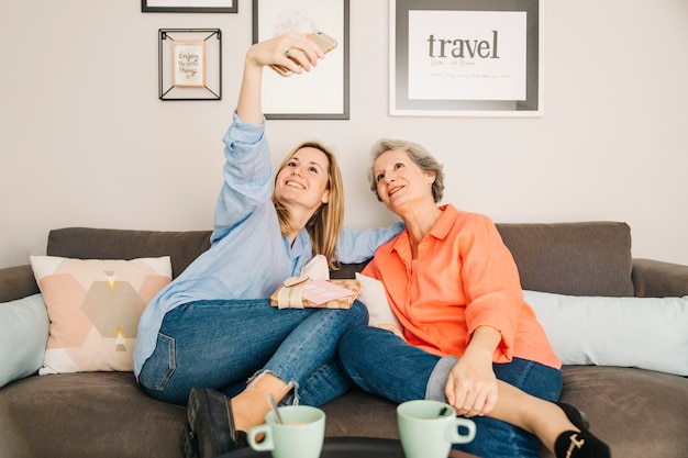 Mothers and daughter taking selfie