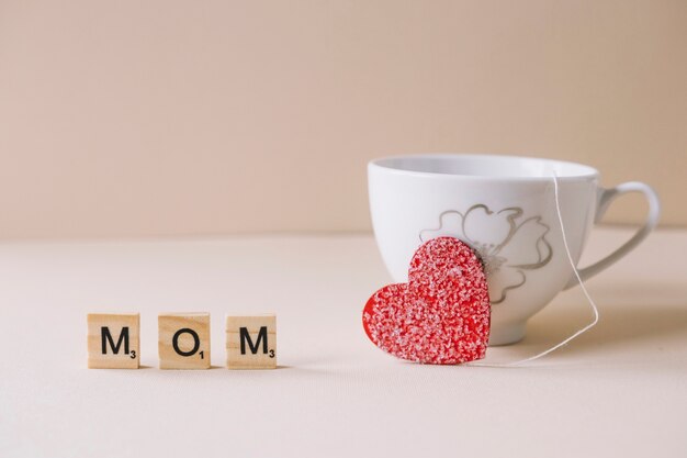 Mothers day composition with cup and sweet heart