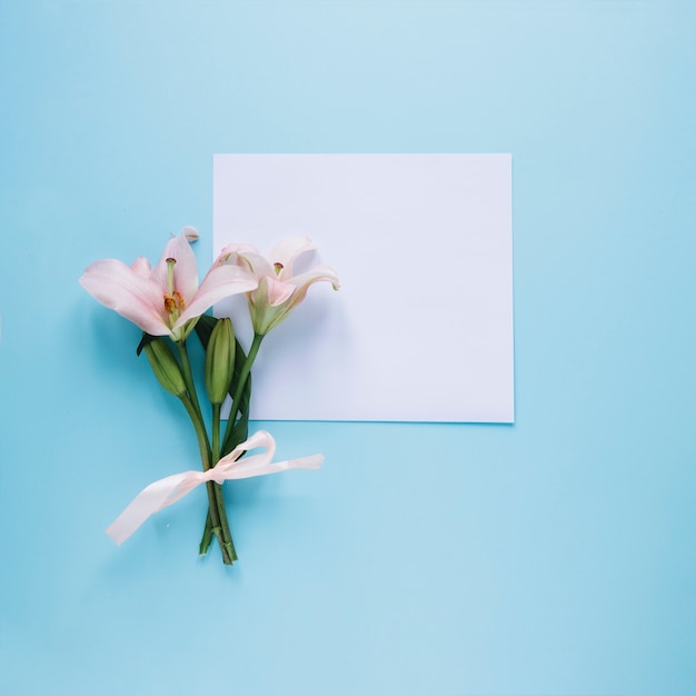 Mothers day composition with flowers and white paper