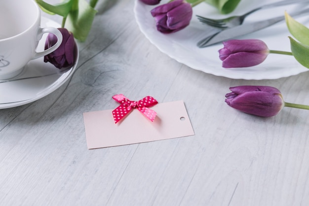 Mothers day composition with purple roses and card