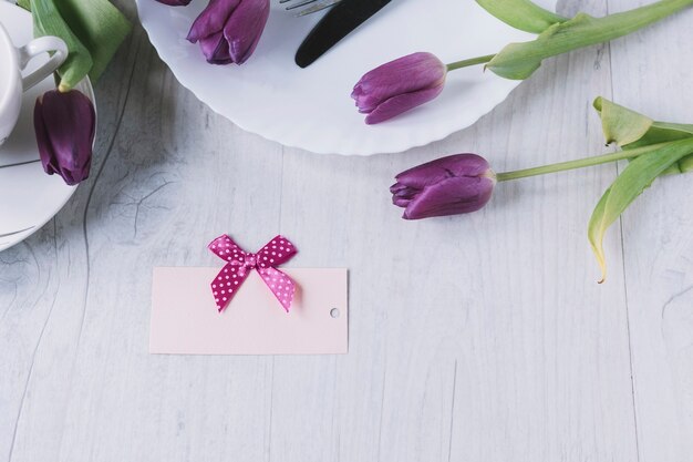 Mothers day composition with purple roses and a card