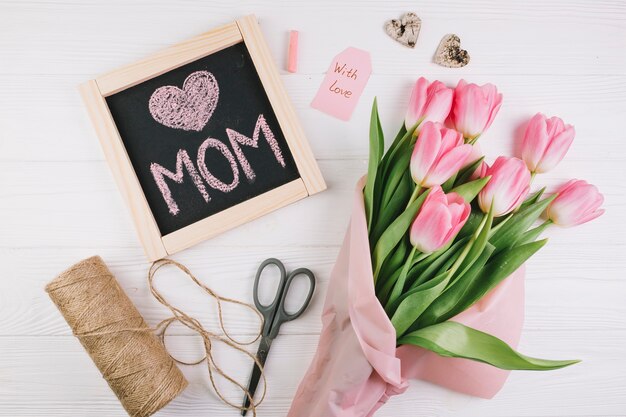 Mothers day composition with slate and bouquet