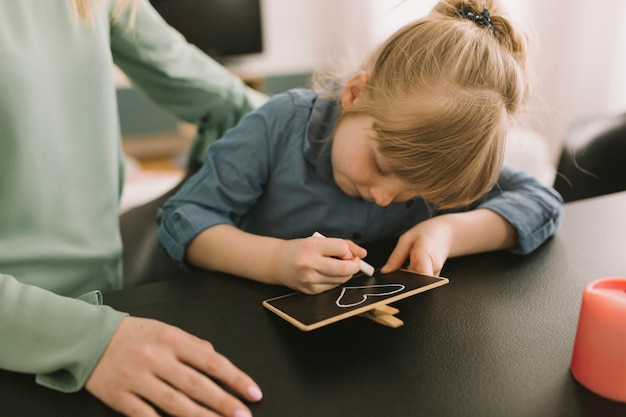 Mothers day concept with kid drawing with chalk