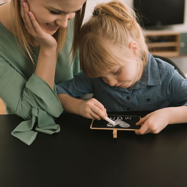 Free photo mothers day concept with kid drawing with chalk