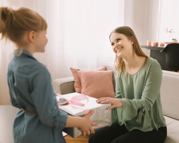 Mothers day concept with kid giving gift box