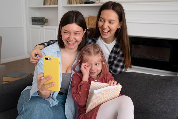 Mothers spending time together with their daughter at home