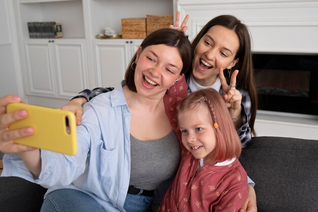 Mothers spending time together with their daughter indoors