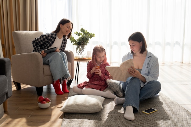 Mothers spending time together with their daughter indoors