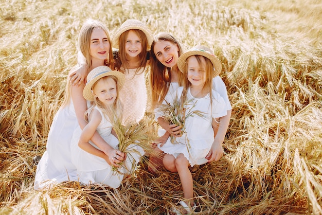 Madri con figlie che giocano in un campo autunnale