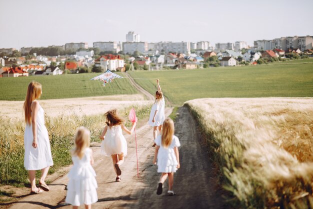 Mothers with daughters playing in an autumn field