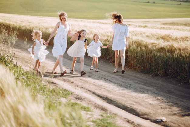 Mothers with daughters playing in an autumn field