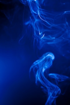 Motion blue smoke on black background. Premium Photo