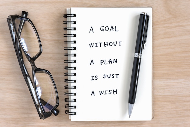 Motivational handwriting on a notebook Free Photo