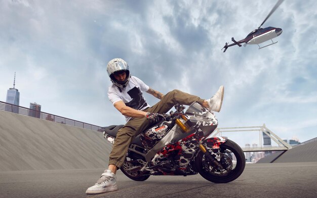 Moto rider making a stunt on his motorbike Biker doing a difficult and dangerous stunt